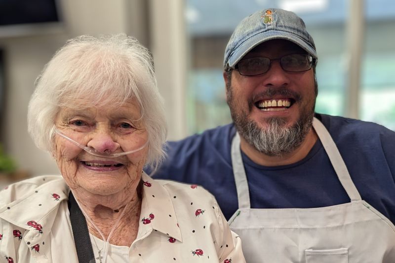 A Nourish Meals on Wheels client and volunteer smiling together