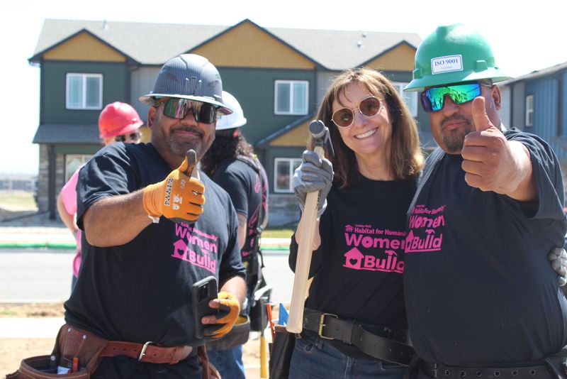 Women Build volunteers giving thumbs up at a Habitat for Humanity site in Greeley